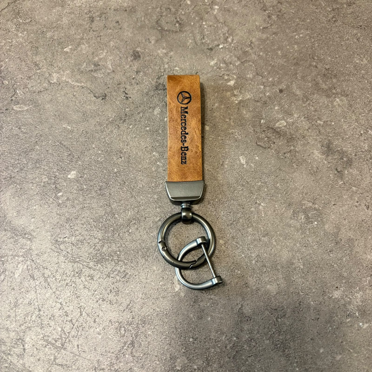 Classic Tan Leather Car Keychain featuring a Mercedes  strap and dark metallic keyring hardware.   