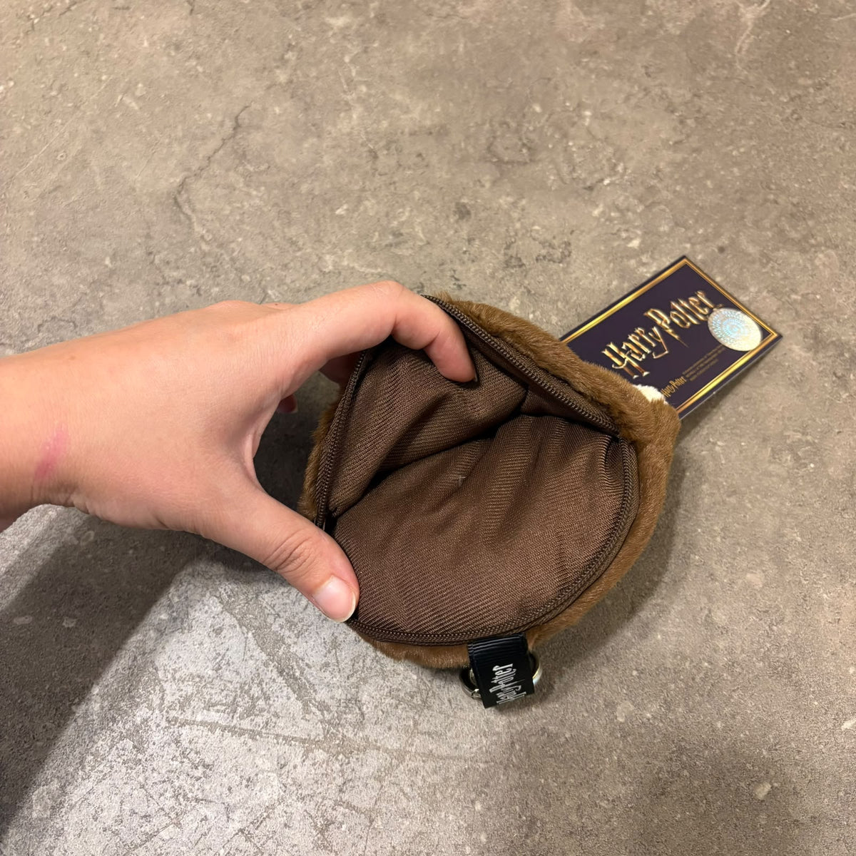 Harry Potter plushie face pouch and bag keychain clip attached to a bag