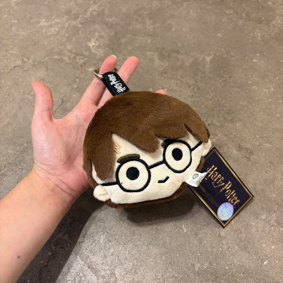 Harry Potter plushie face pouch and bag keychain clip attached to a bag