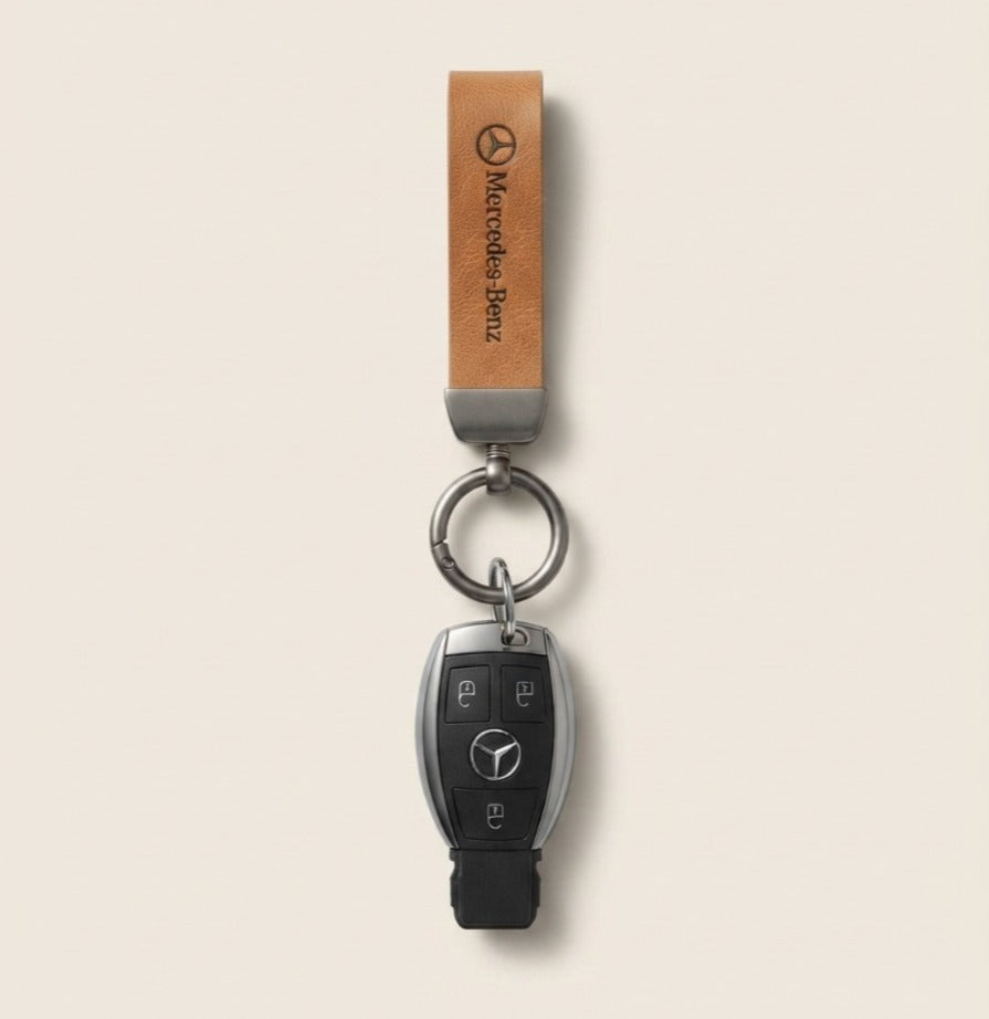 Classic Tan Leather Car Keychain featuring a Mercedes-Benz logo strap and dark metallic keyring hardware.   