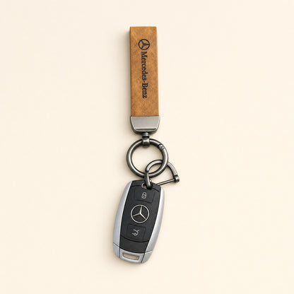 Classic Tan Leather Car Keychain featuring a Mercedes strap and dark metallic keyring hardware.   