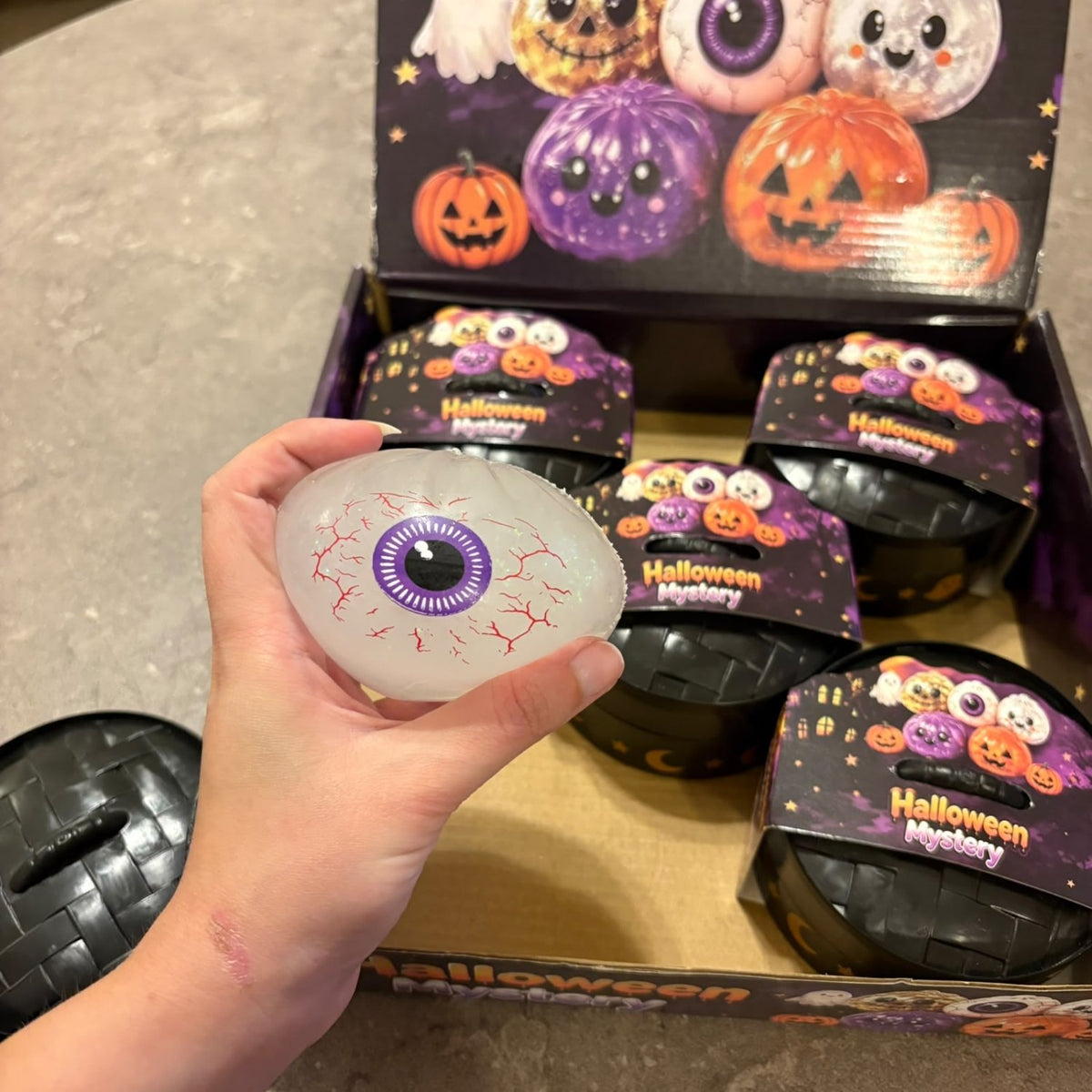 Glitter Dumpling Squishy Toy Halloween Edition blind box packaging, featuring a cute and stretchy novelty stress toy with sparkly glitter filling.